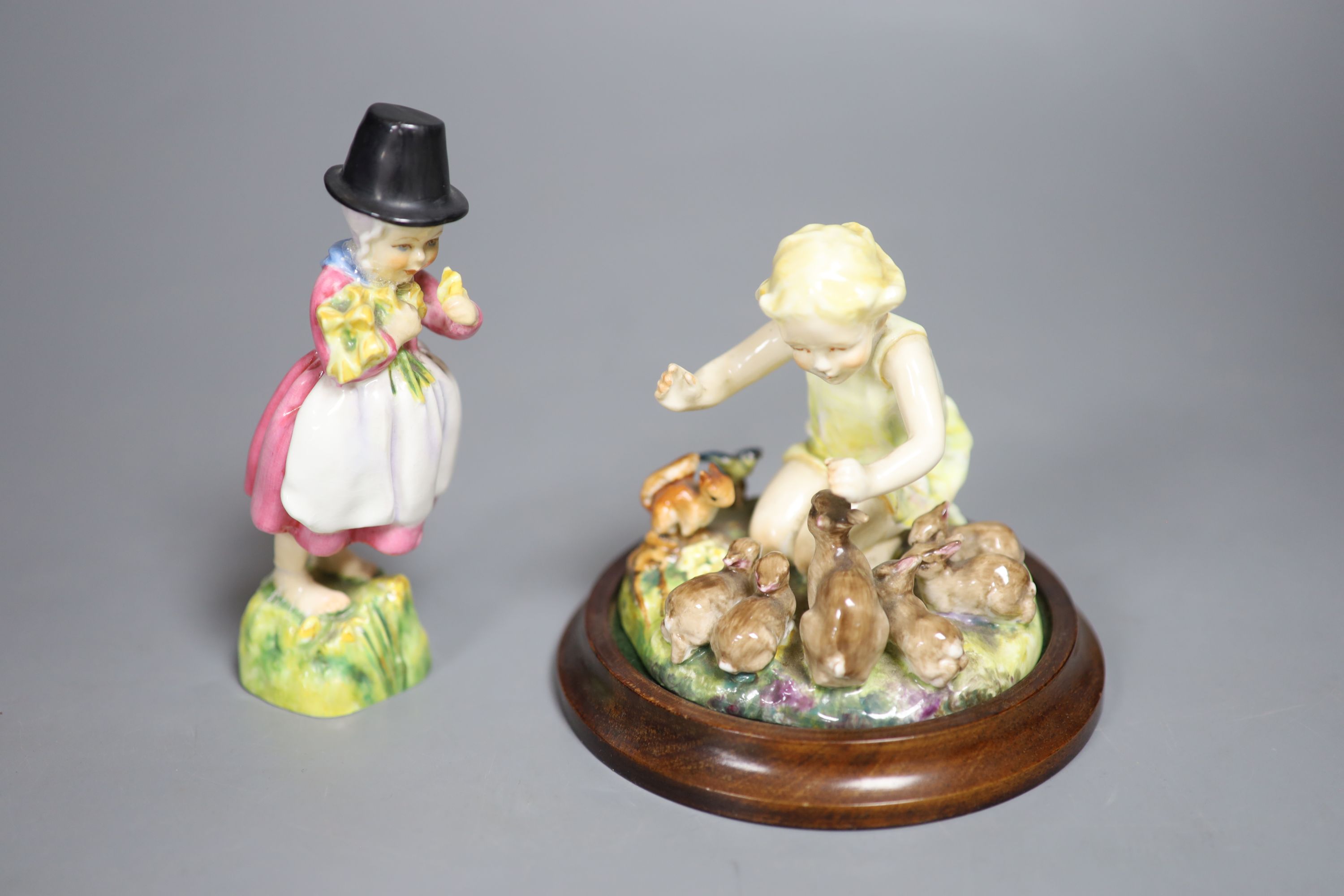 Four Royal Worcester figures of children by E.G. Doughty: 3150, 3076, 3103, 1416, and a larger Staffordshire table centre of a boy and